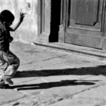 Boy dancing with his shadow