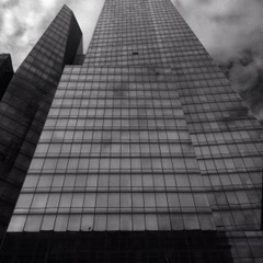 View of a skyscraper from the street in front of the building